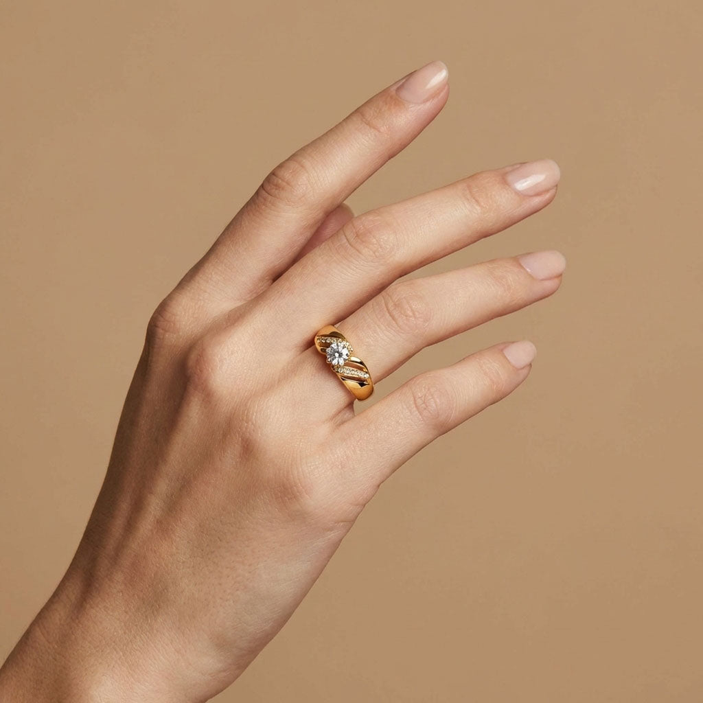 Cubic zirconia ring in gold tone on a woman's finger, warm beige background