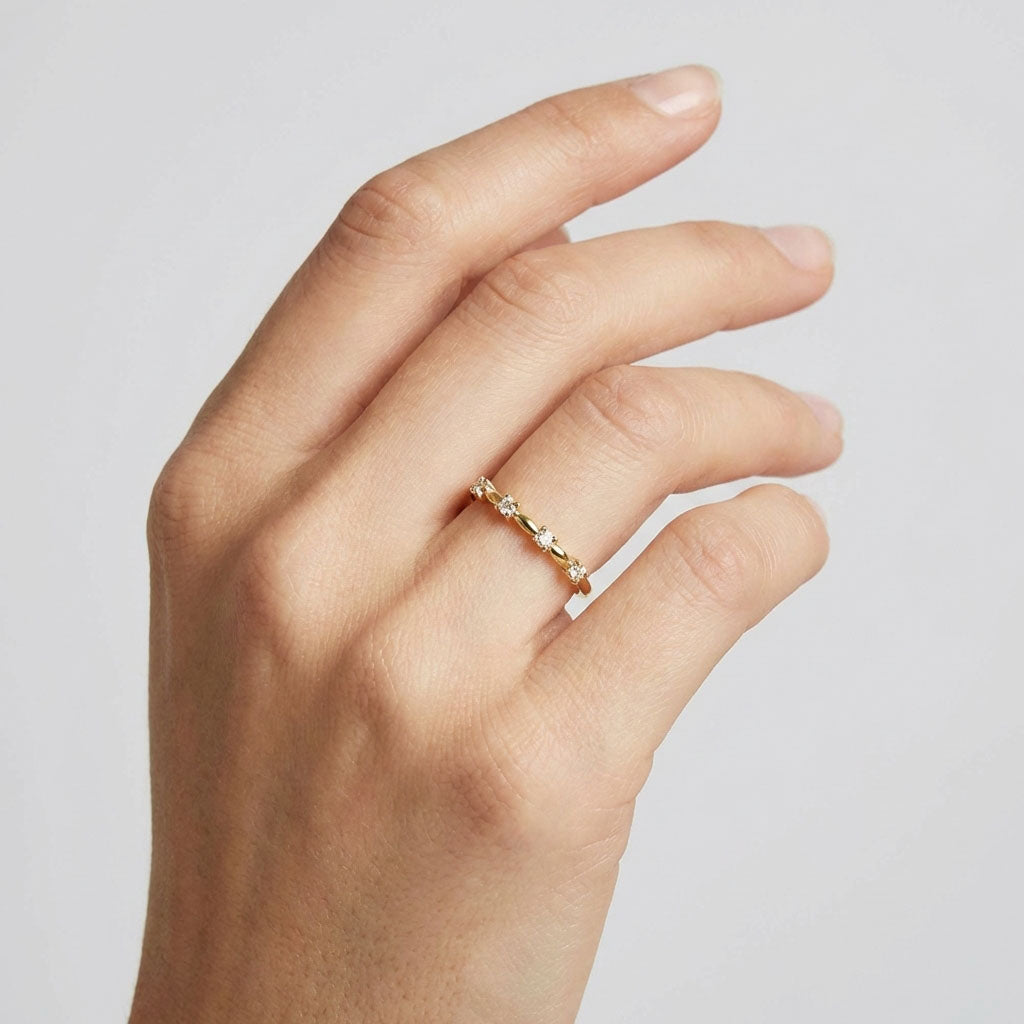 Gold-plated cubic zirconia ring on a woman's finger in a bright studio