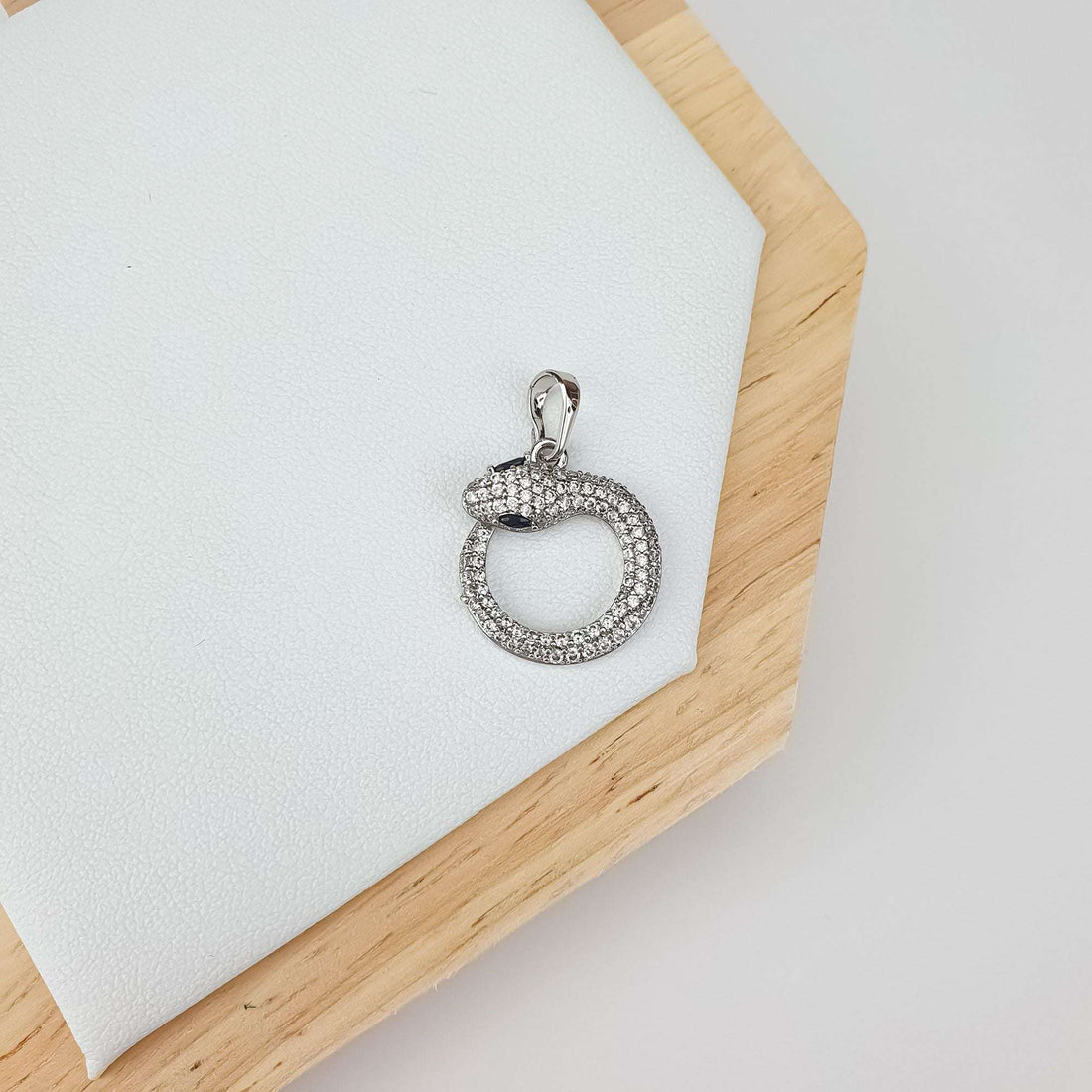Silver-tone snake coiled in a ring, covered in white cubic zirconia, dark eyes