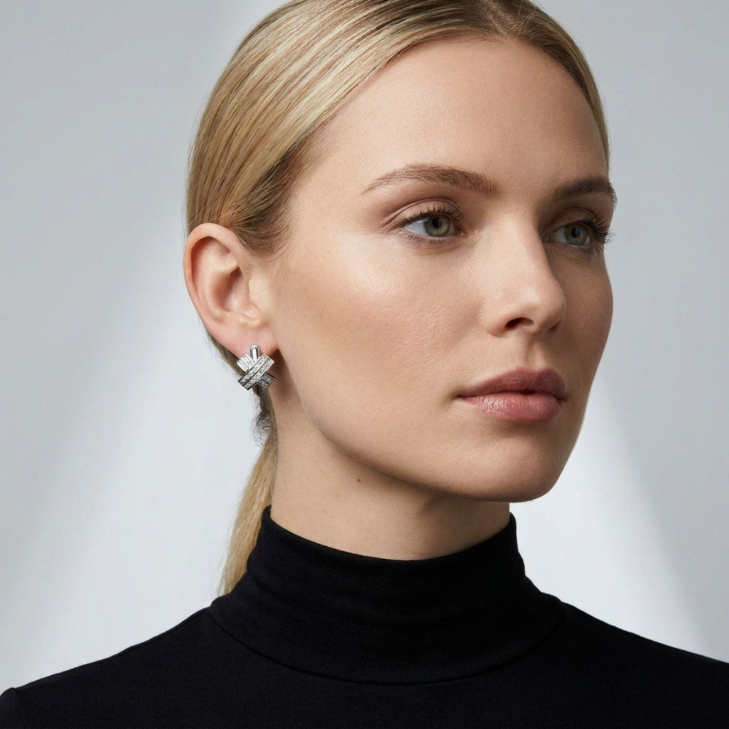 Model in a black polo neck wearing sparkling criss-cross earrings