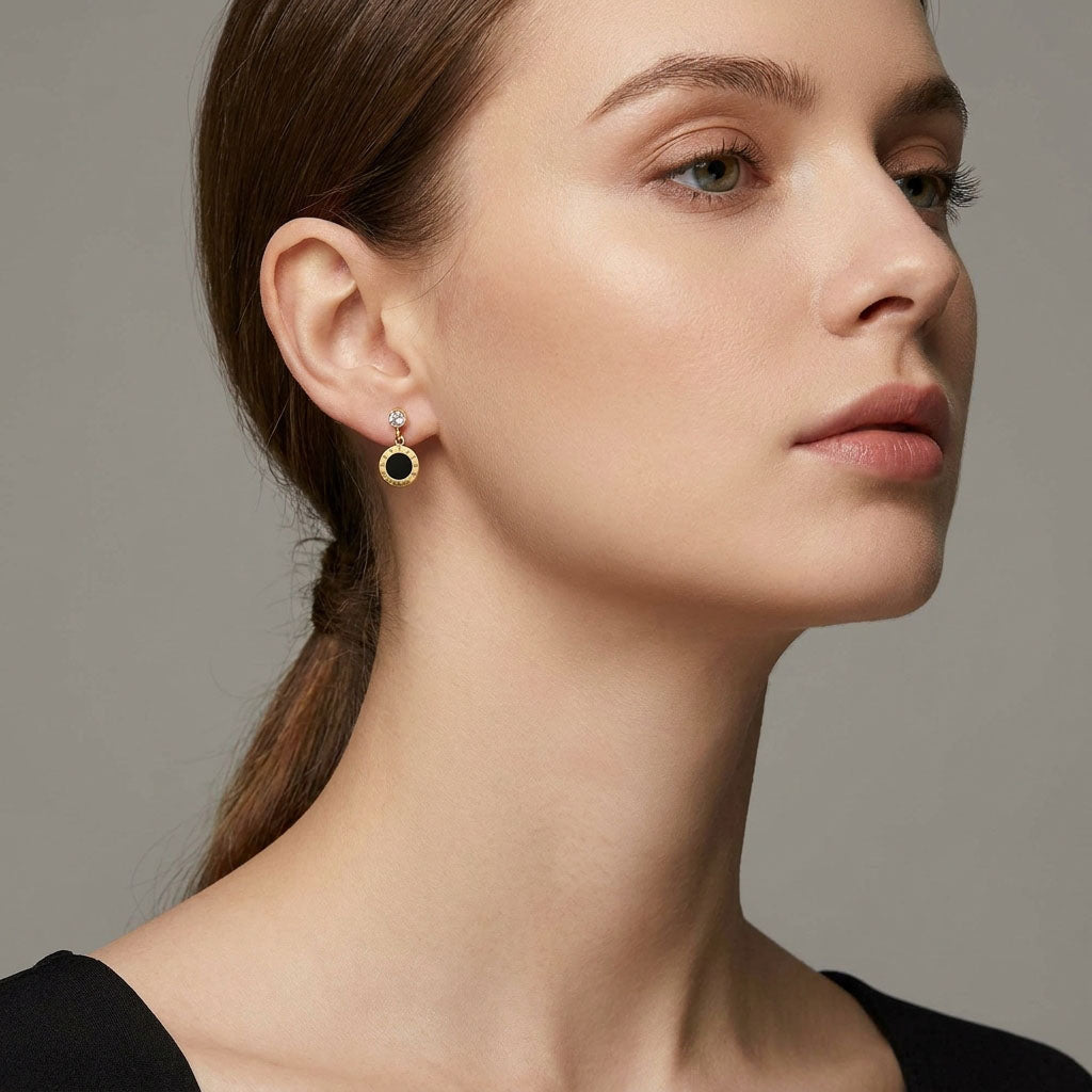 Black circle earring with clear crystal on a model's ear, side view