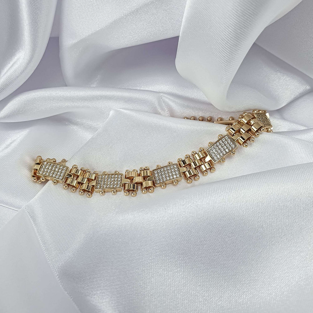 Gold-plated watch-strap style bracelet with cubic zirconia on white silk