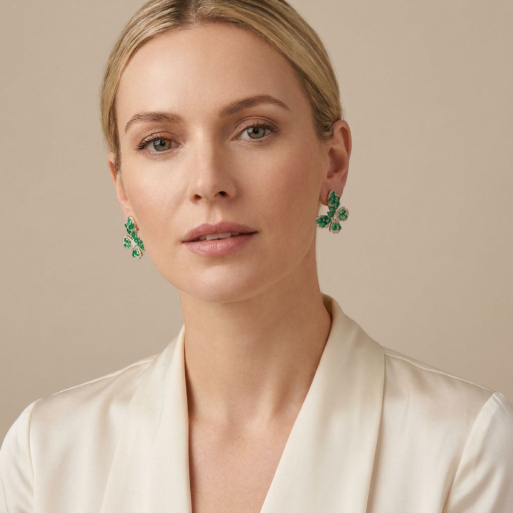 Model wearing a gold-plated green butterfly earring, side close-up on beige