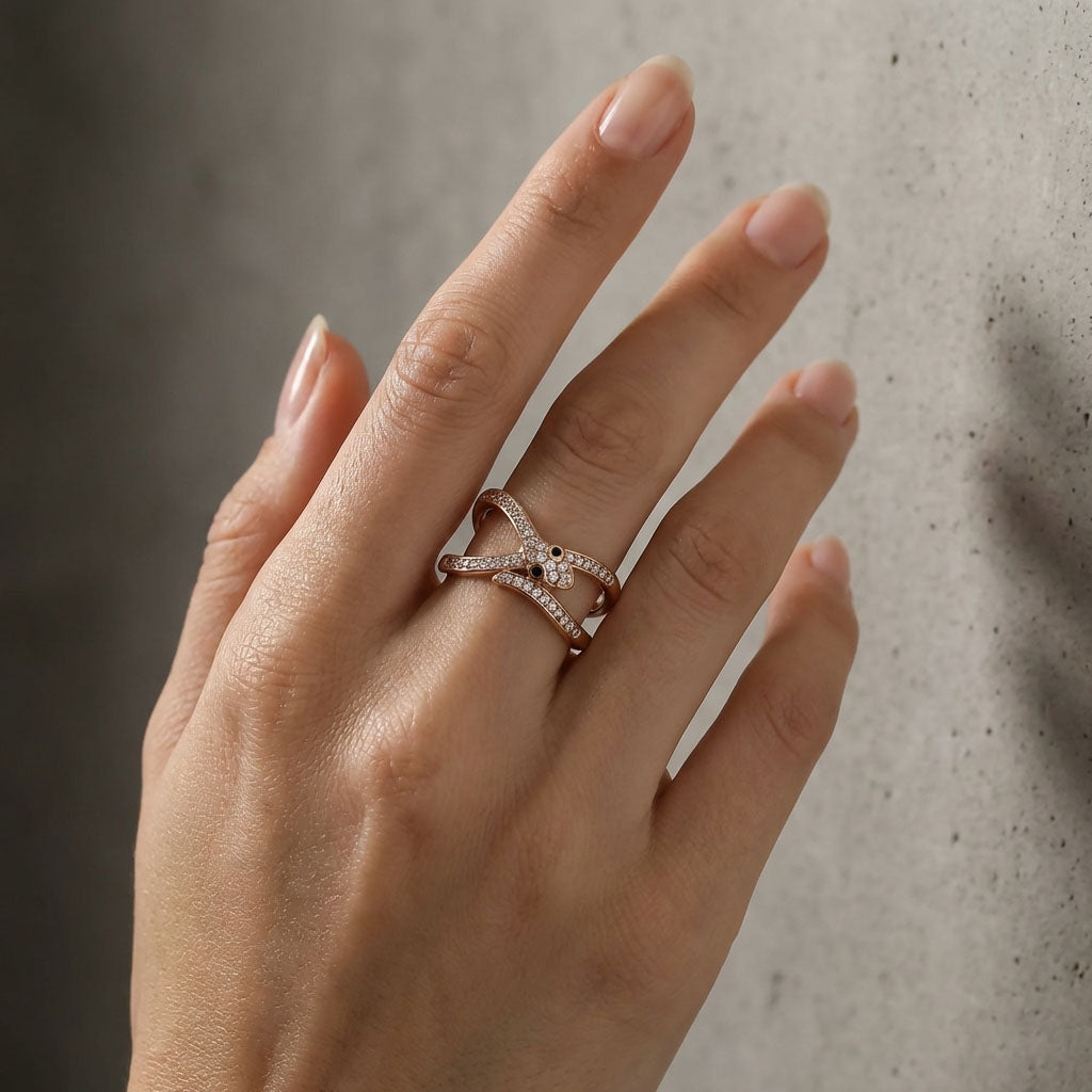 Snake ring on a woman's finger, two bands of sparkling cubic zirconia