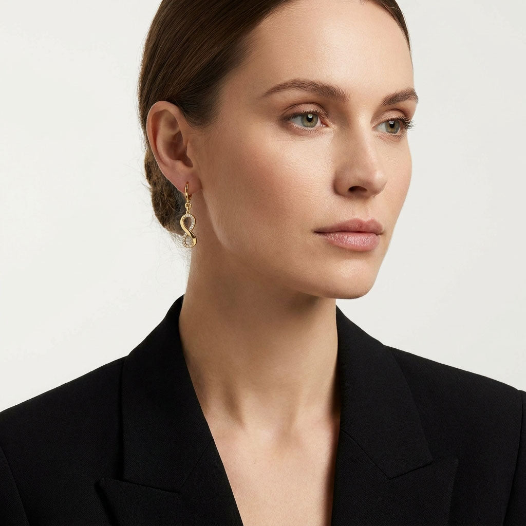 Model in a black jacket wearing an infinity earring with sparkling stones