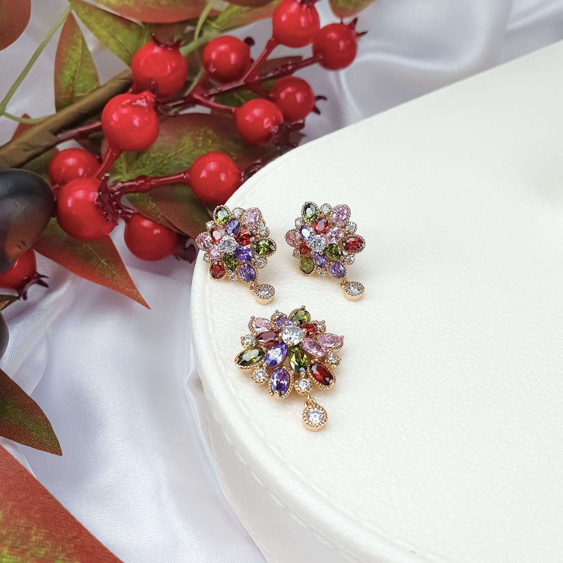 Gold-plated flower earrings and pendant with red, violet and green cubic zirconia