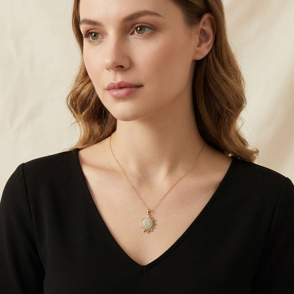 Model in a black blouse wearing the sun pendant on a fine chain