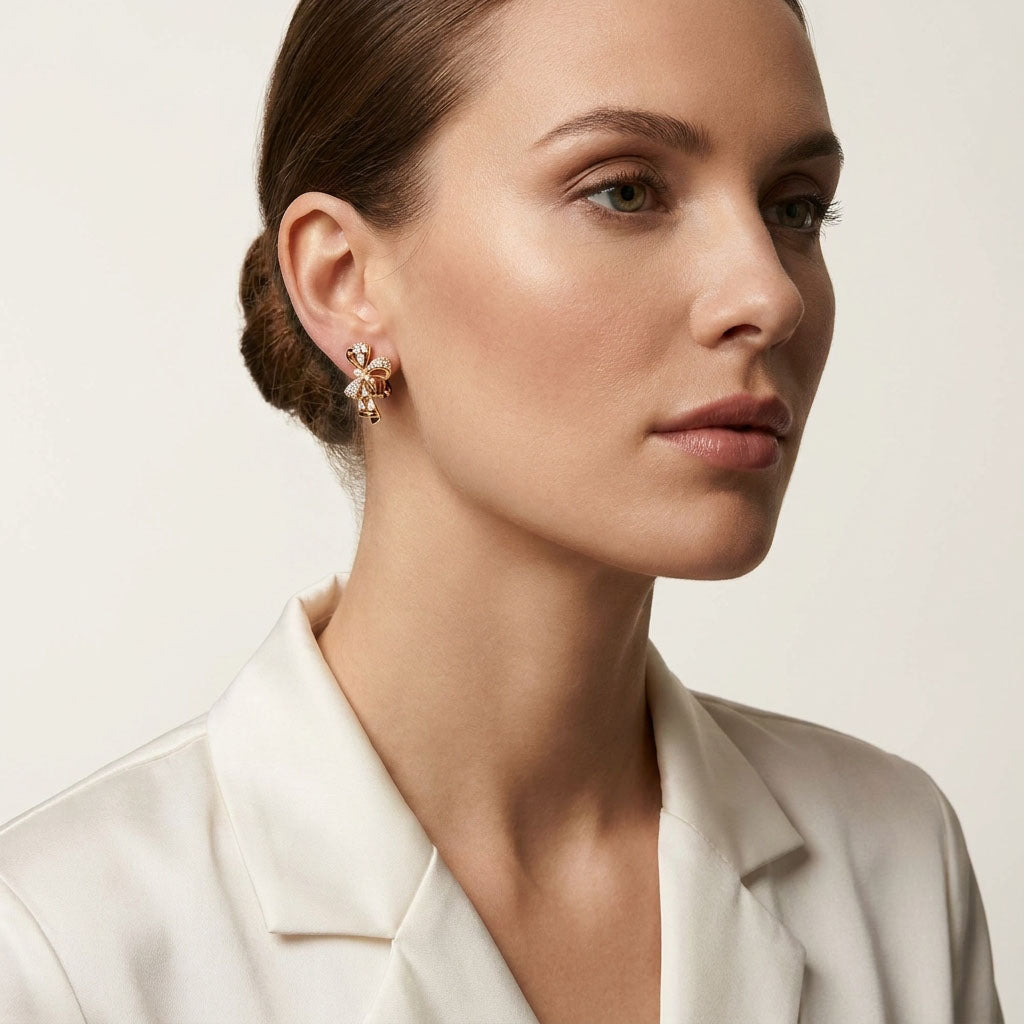 Bow clip-on earring on a model with a white blazer and hair up