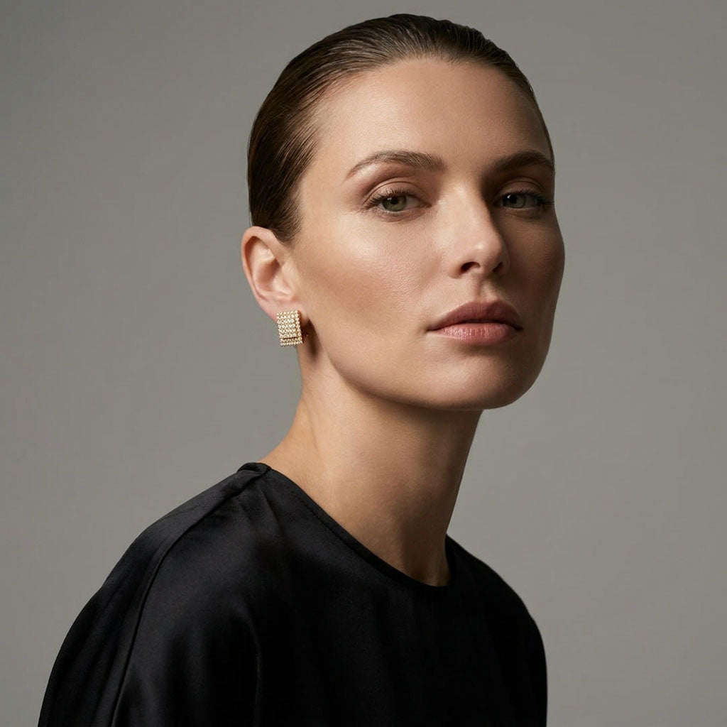 Model in a black blouse wearing sparkling rectangular cubic zirconia clip-ons