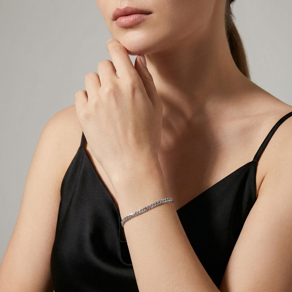 Silver-tone Rombo chain bracelet on a woman's wrist by a black top