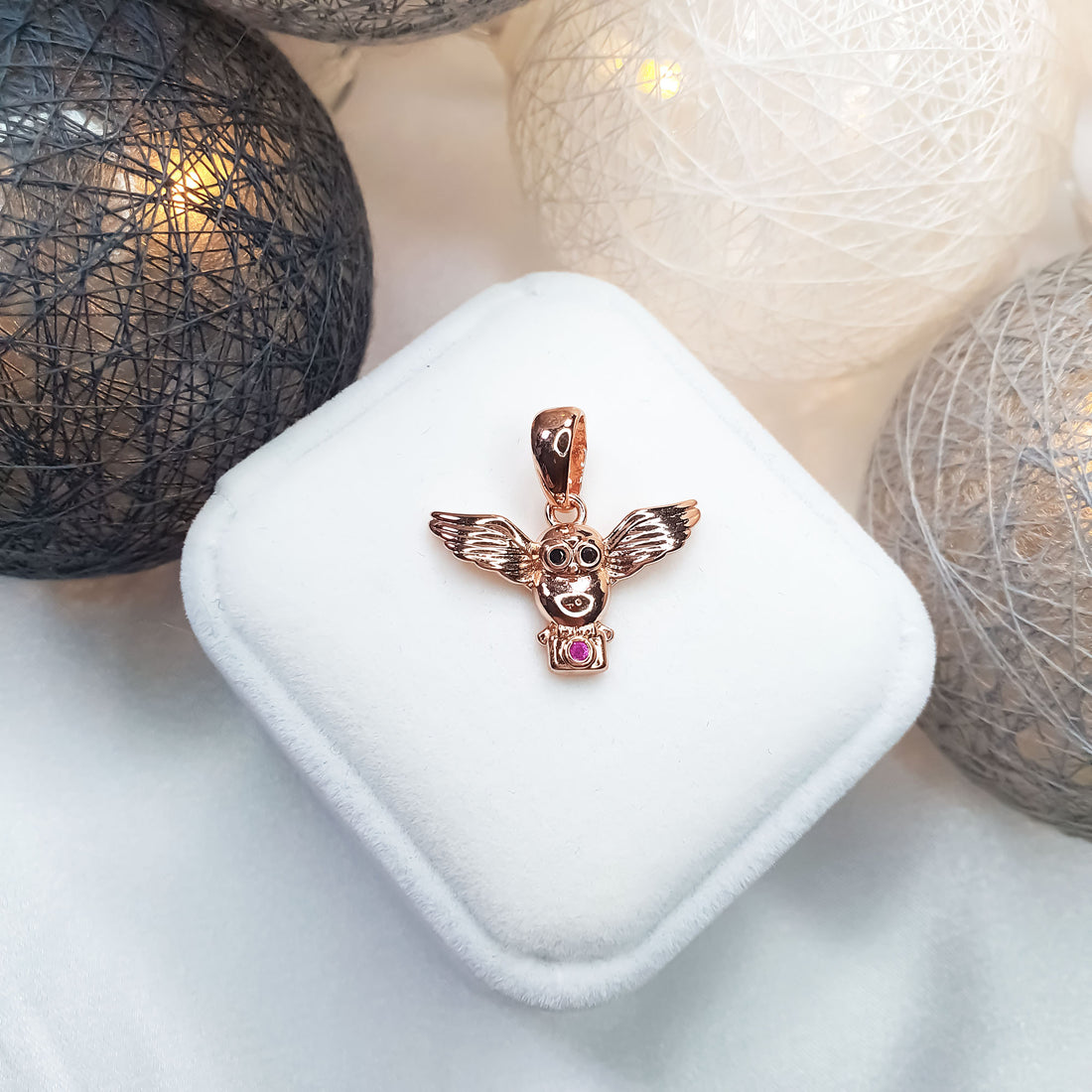 Winged owl pendant in a warm gold tone on a white box