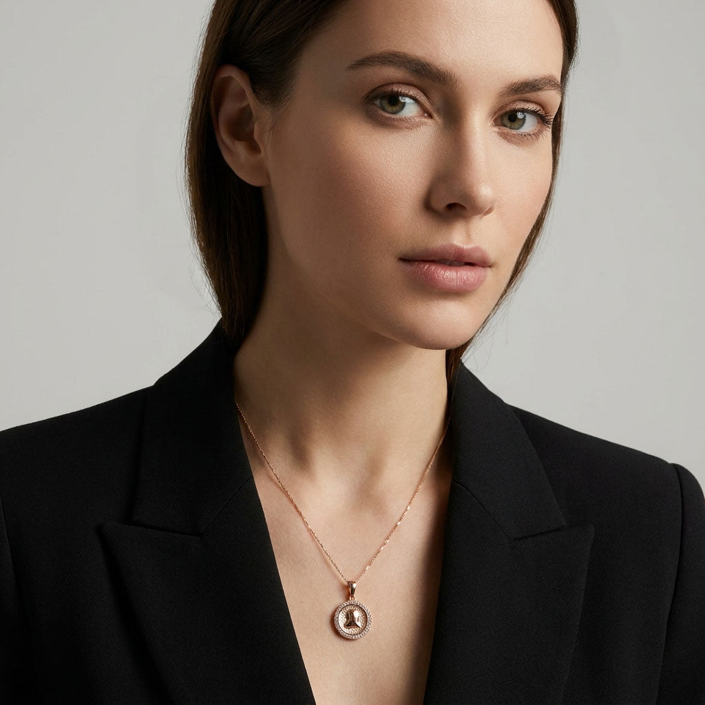 Model in a black jacket wearing the round heart pendant on a fine chain
