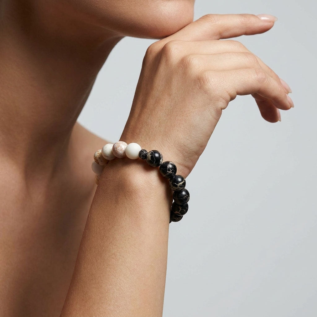 Woman wearing a stone bead bracelet with alternating light and black beads