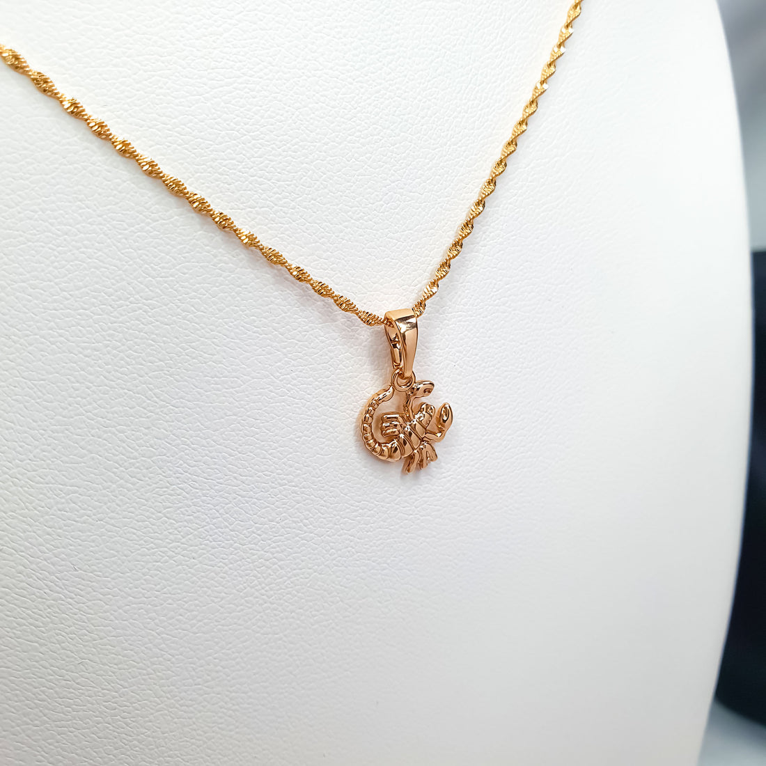 Gold-tone Scorpio zodiac pendant on a fine twisted chain