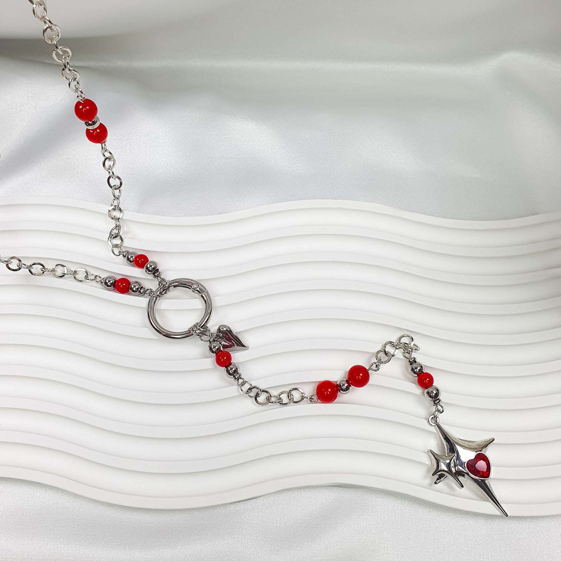 Long chain with red beads, silver-tone heart and star with red stone