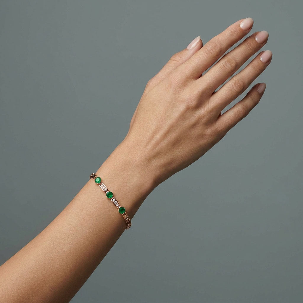 Green crystal bracelet on a woman's wrist, gold-plated link design