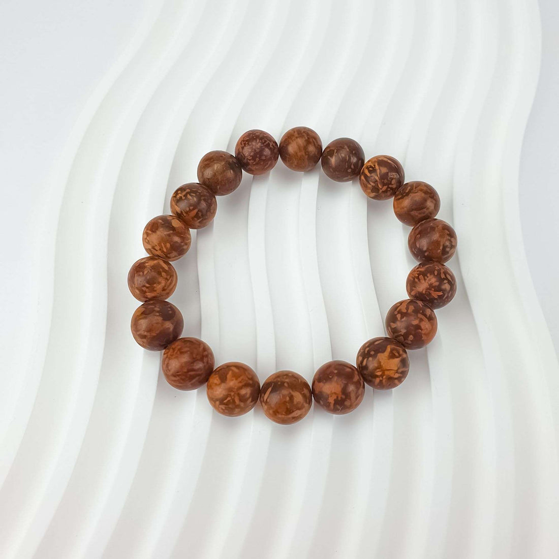 Close-up of chrysanthemum stone beads showing each bead's unique pattern