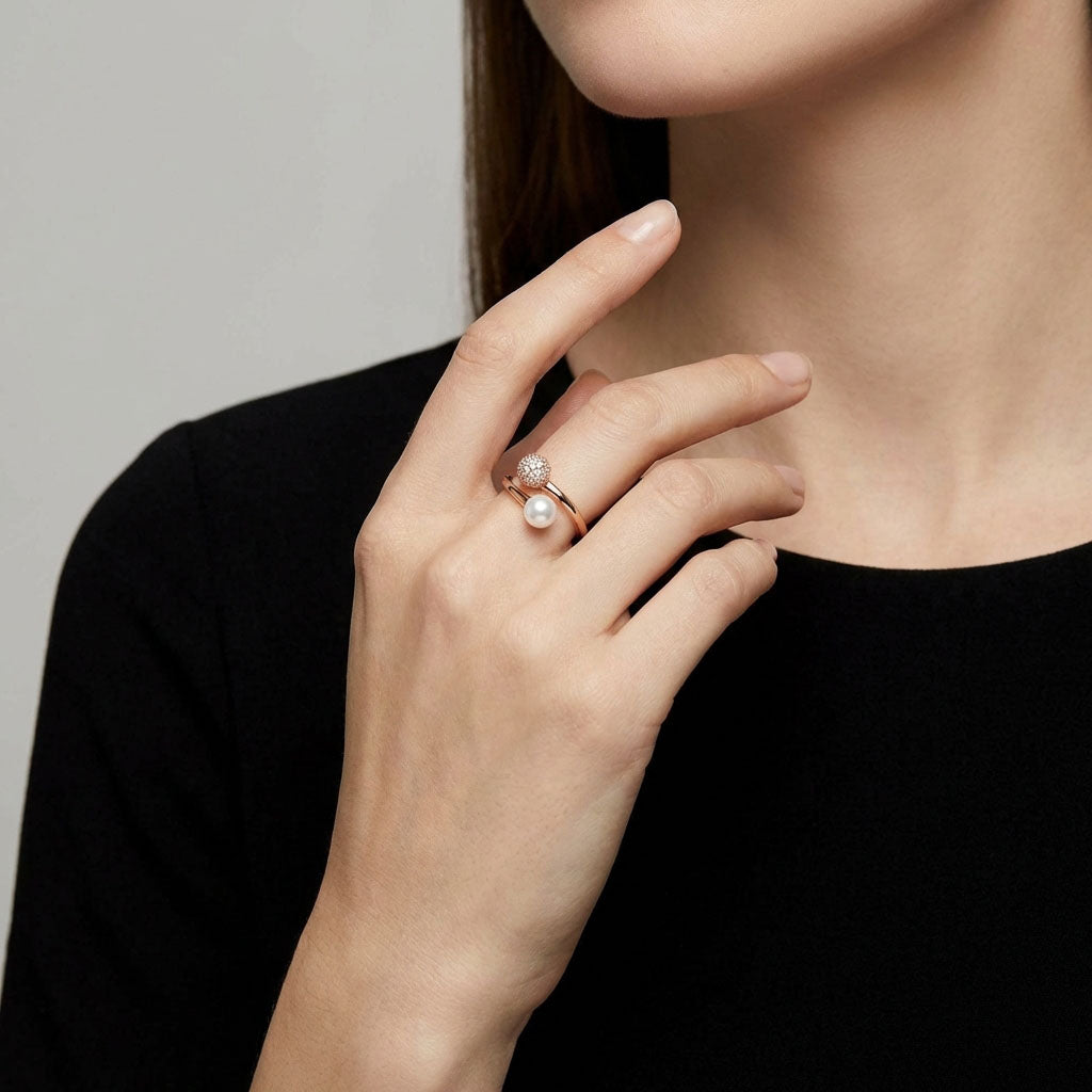 Model wearing the gold-plated pearl ring, dark outfit in the background