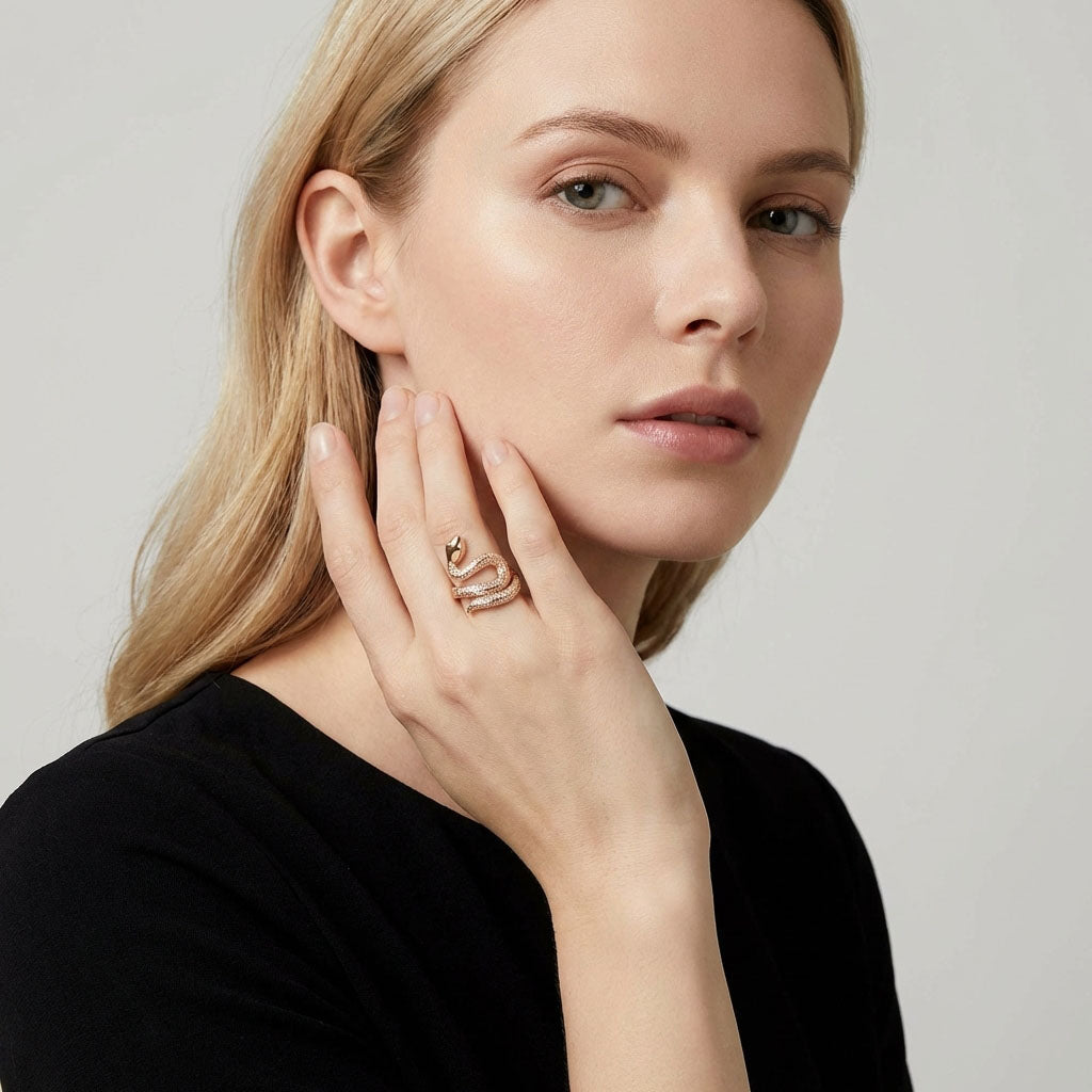 Model in a black blouse wearing the gold-plated snake ring, hand at her face