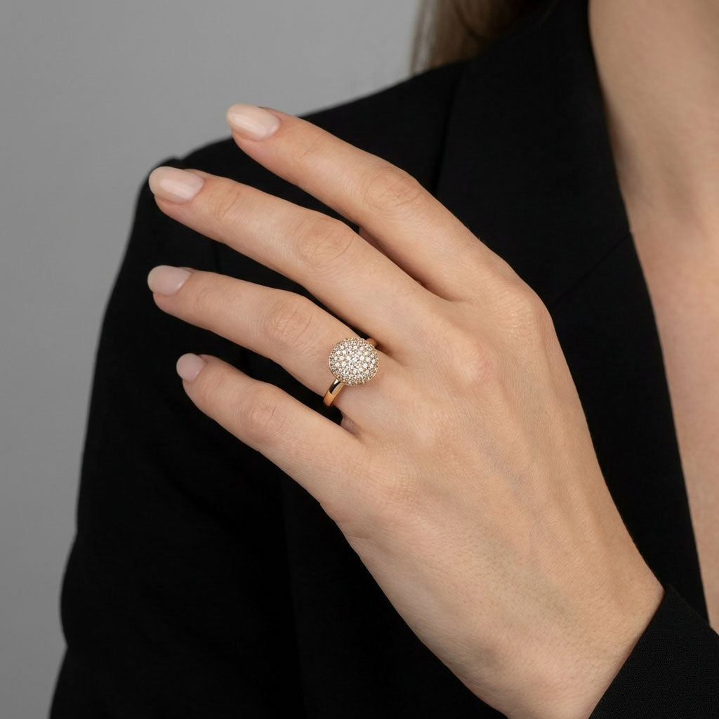 Sparkling cubic zirconia ring on a woman's finger with a black jacket