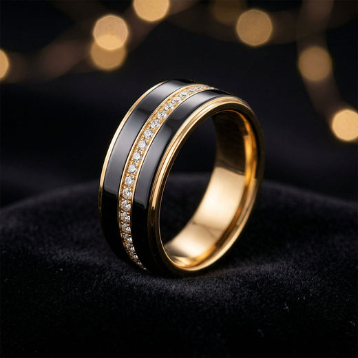 Black ceramic ring with a gold-tone band and cubic zirconia on dark velvet