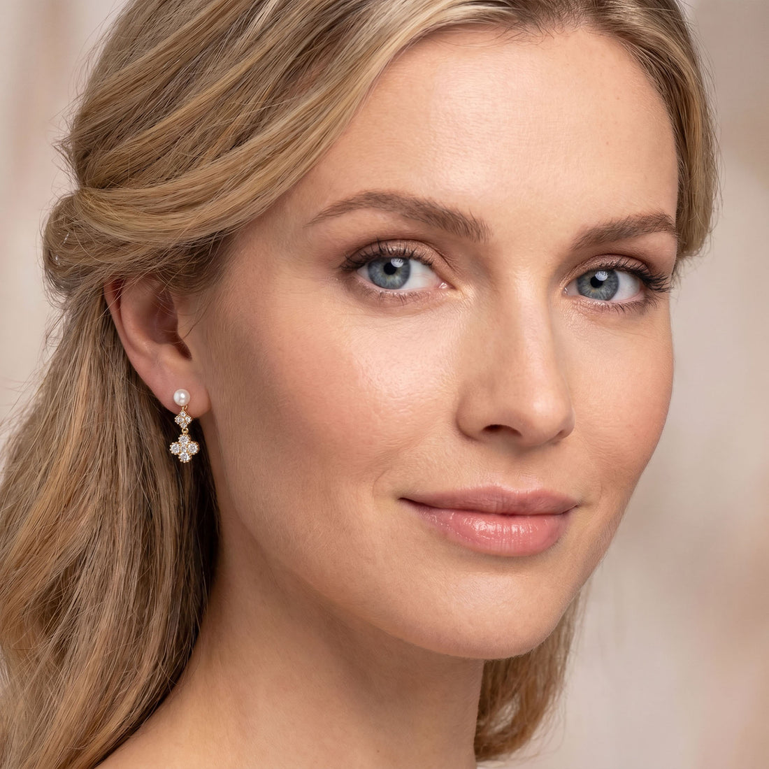 Stud earrings with a faux pearl and cubic zirconia