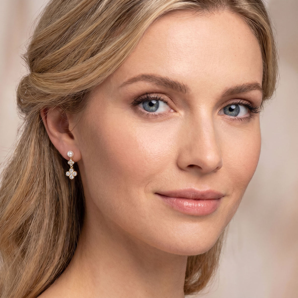 Stud earrings with a faux pearl and cubic zirconia