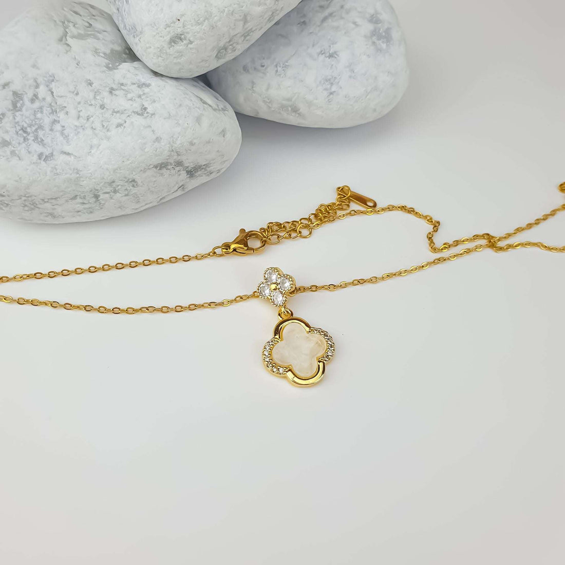 Clover necklace laid flat, showing the lobster clasp and cubic zirconia frame