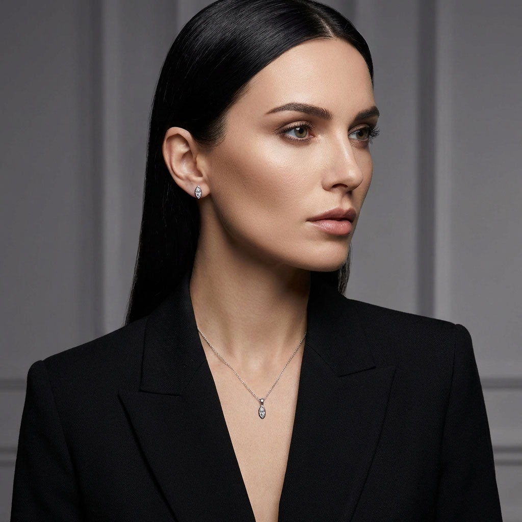 Model in a black jacket wearing silver-tone marquise earrings and a pendant
