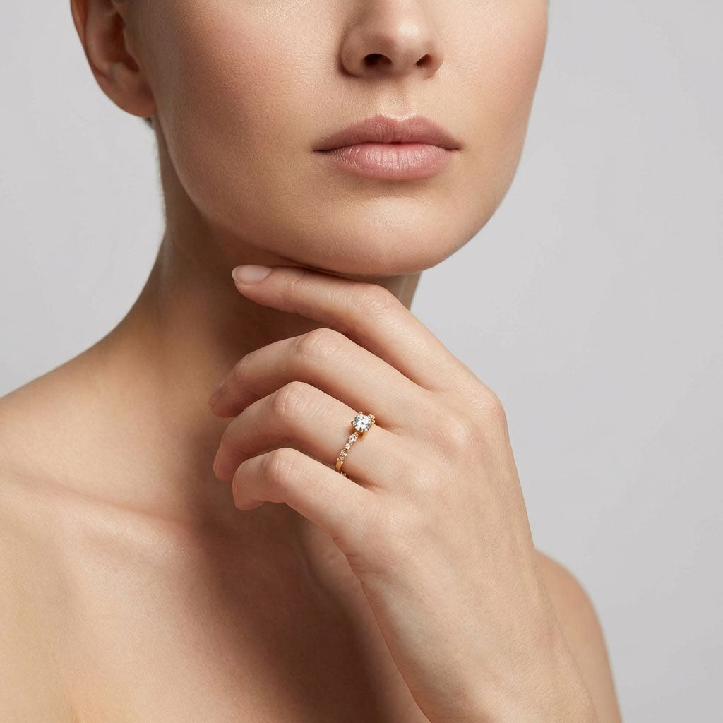 Round cubic zirconia ring worn on a woman's finger