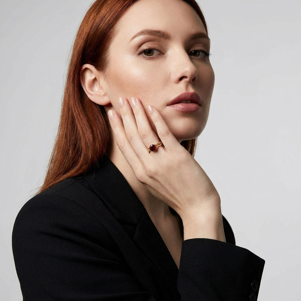Red stone ring on a model's finger with a black jacket