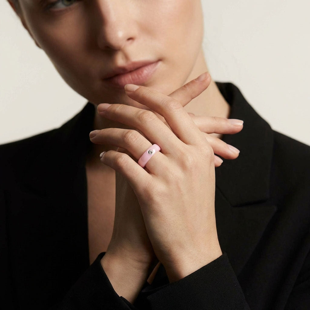 Woman in a black jacket wearing the pink ceramic ring with cubic zirconia