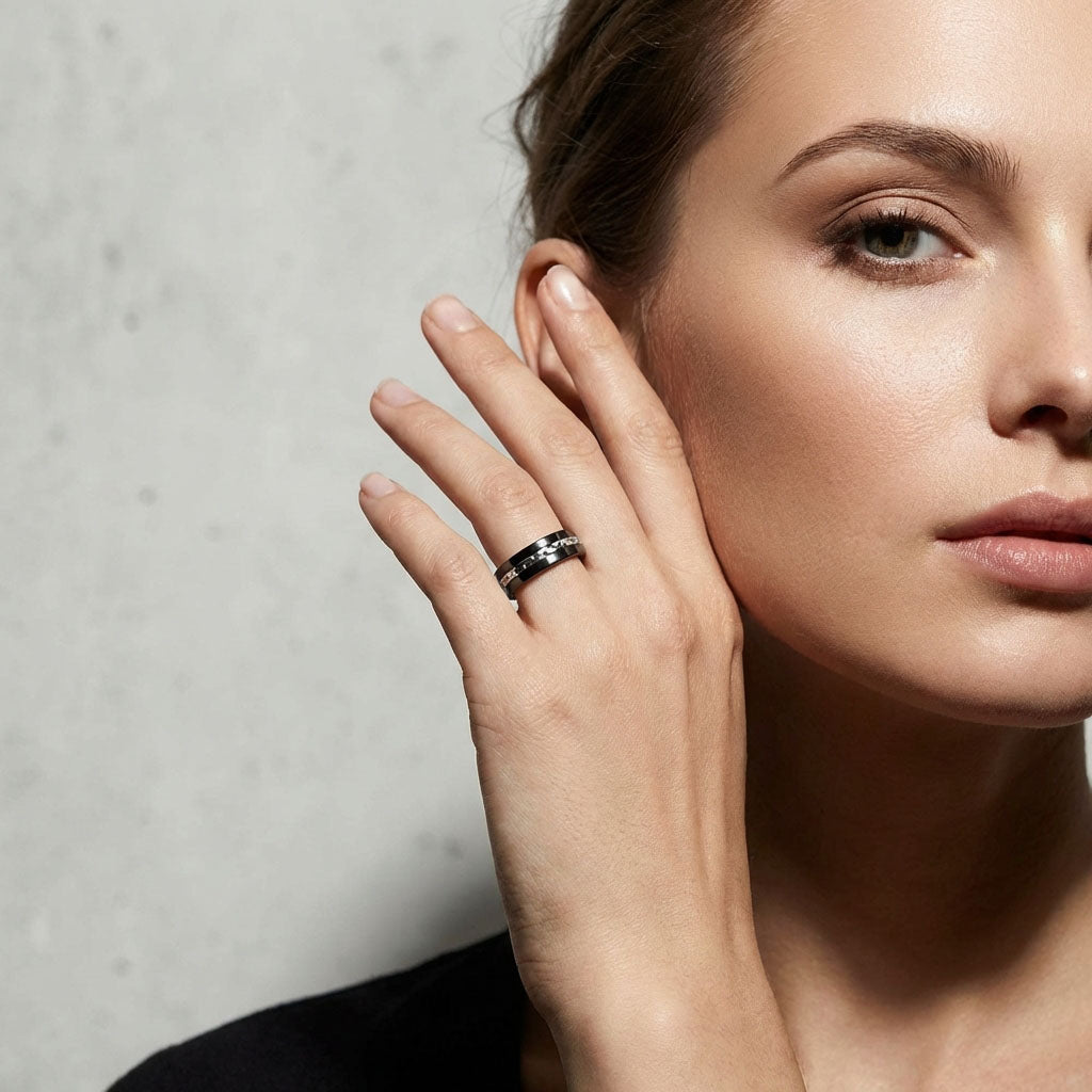 Woman holding her hand to her face, wearing the black ceramic ring