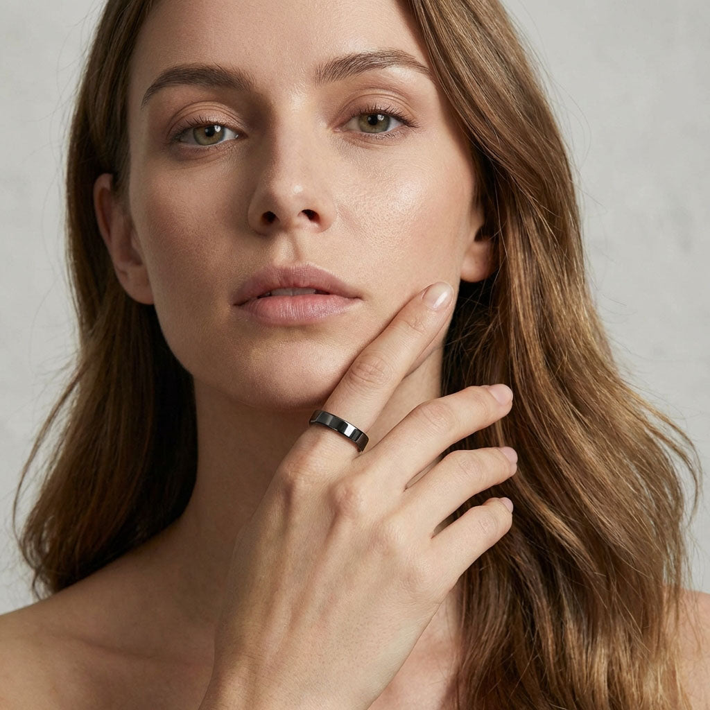 Woman wearing a black ceramic ring, close-up of the minimalist design
