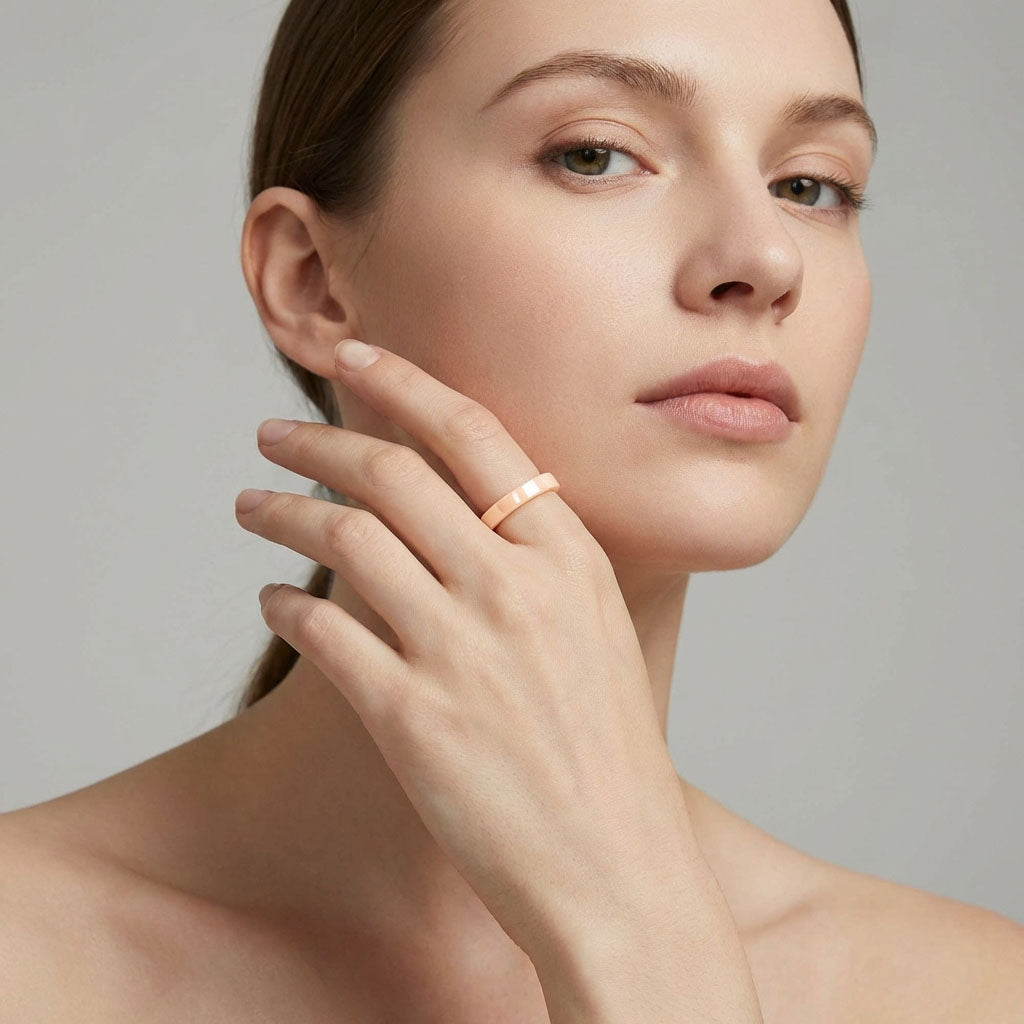 Beige ceramic ring on a model's middle finger, blending with her skin