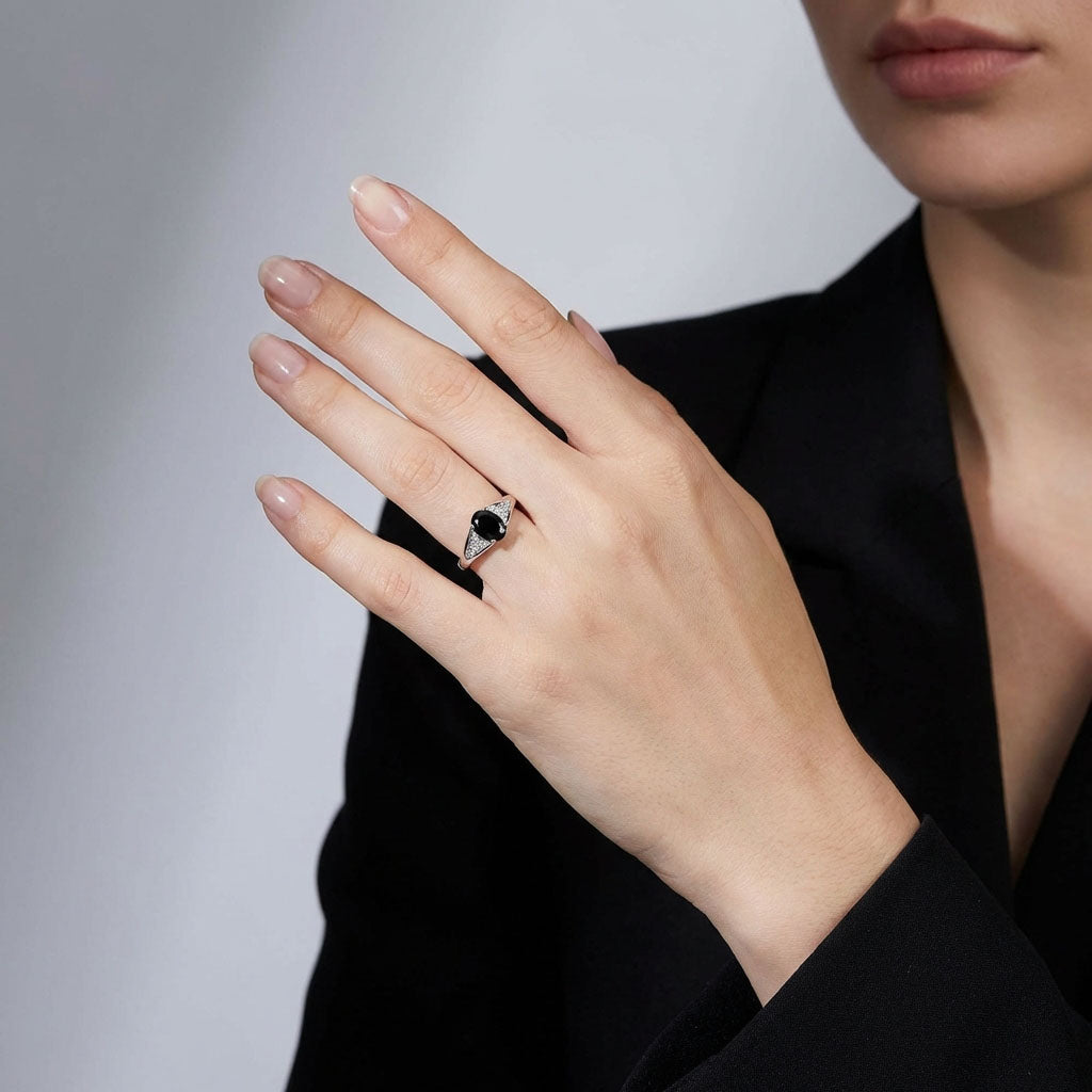 Black stone ring on a model's finger with a black jacket
