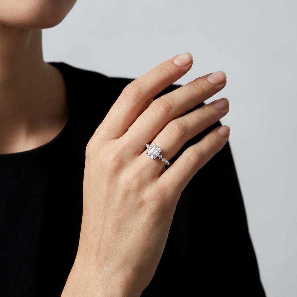 Model in a black jumper wearing a silver-tone rectangular crystal ring