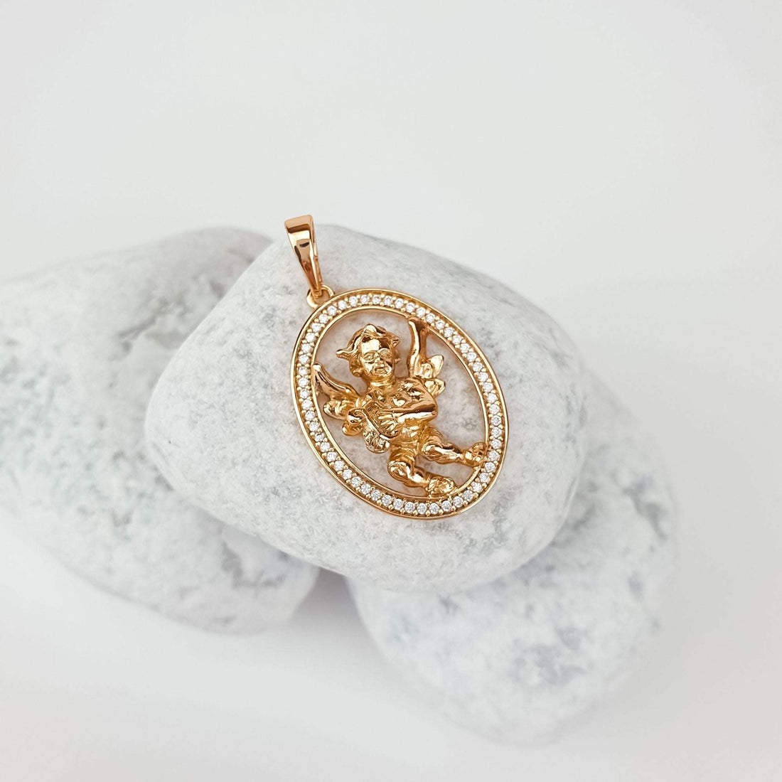 Gold-tone angel pendant with a lyre and cubic zirconia frame on light stones