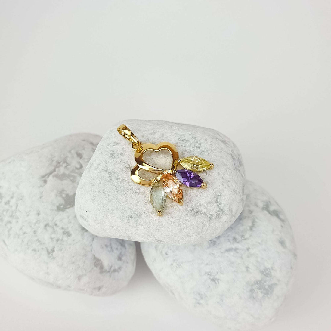 Gold-plated hearts pendant with yellow, violet and peach stones on white pebbles
