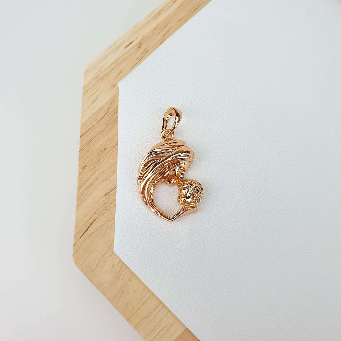 Pendant with a mother and child motif on a wooden stand