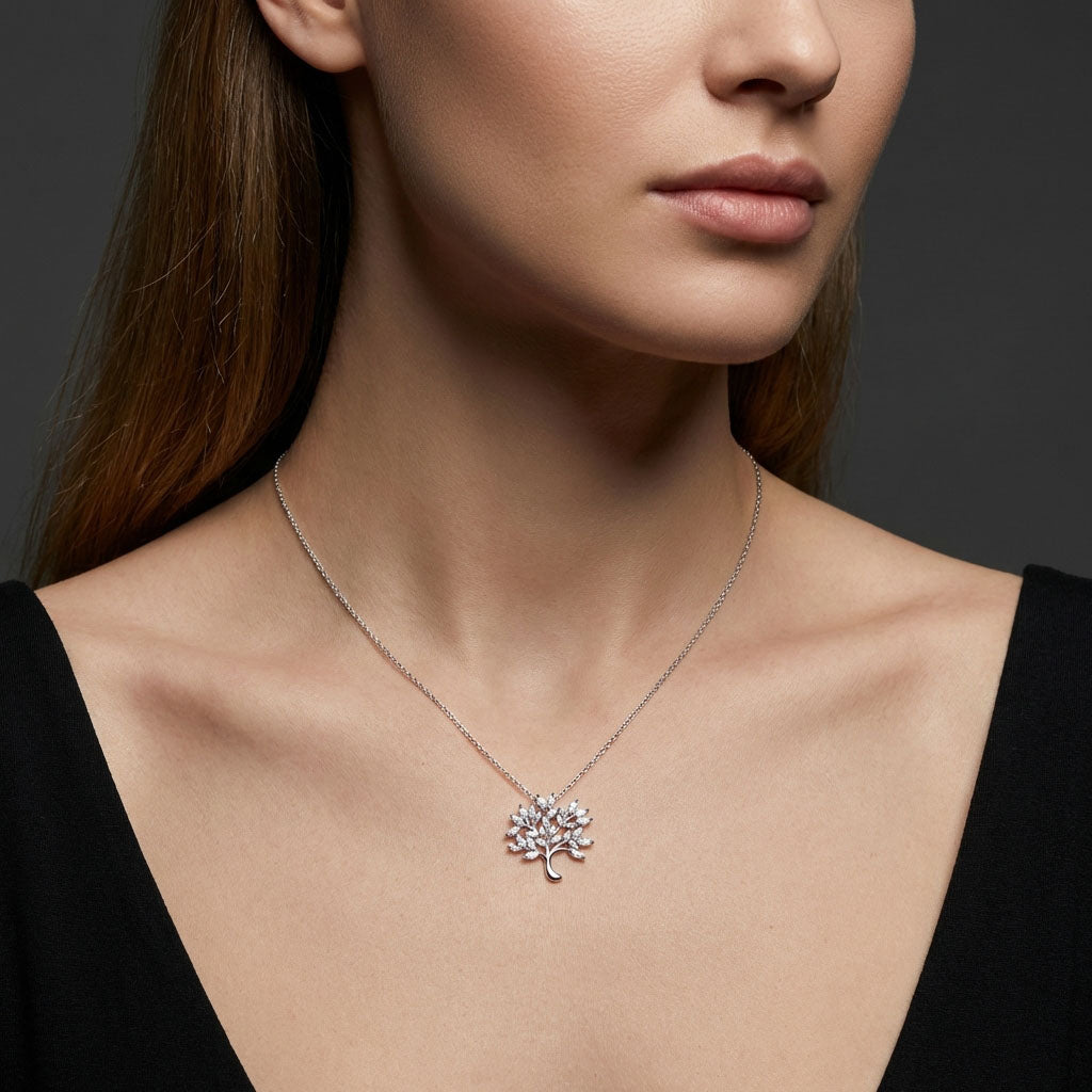 Tree of life pendant on a fine chain around a model's neck, dark background