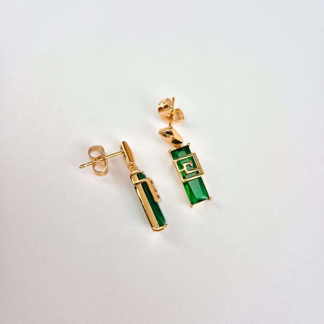 Pair of green stone earrings at an angle with gold-plated posts
