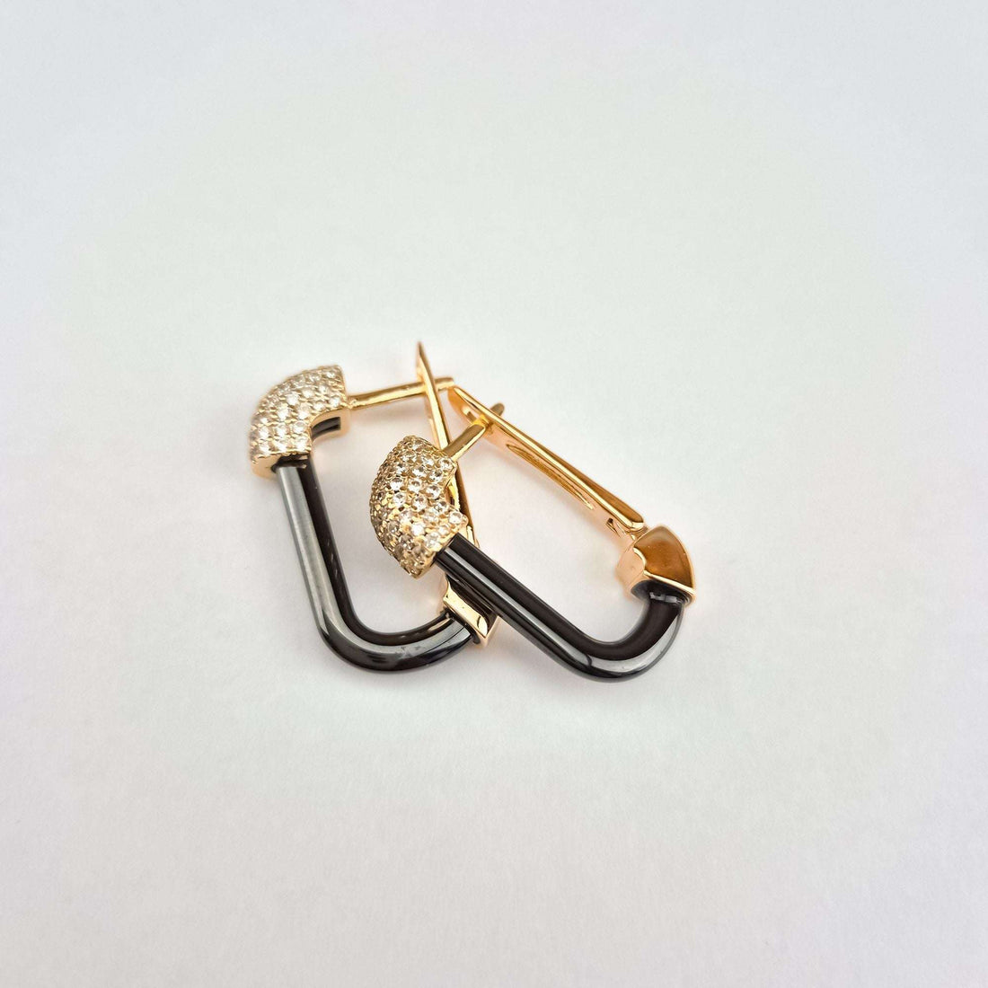 Side view of black ceramic earrings with leverbacks and cubic zirconia heads