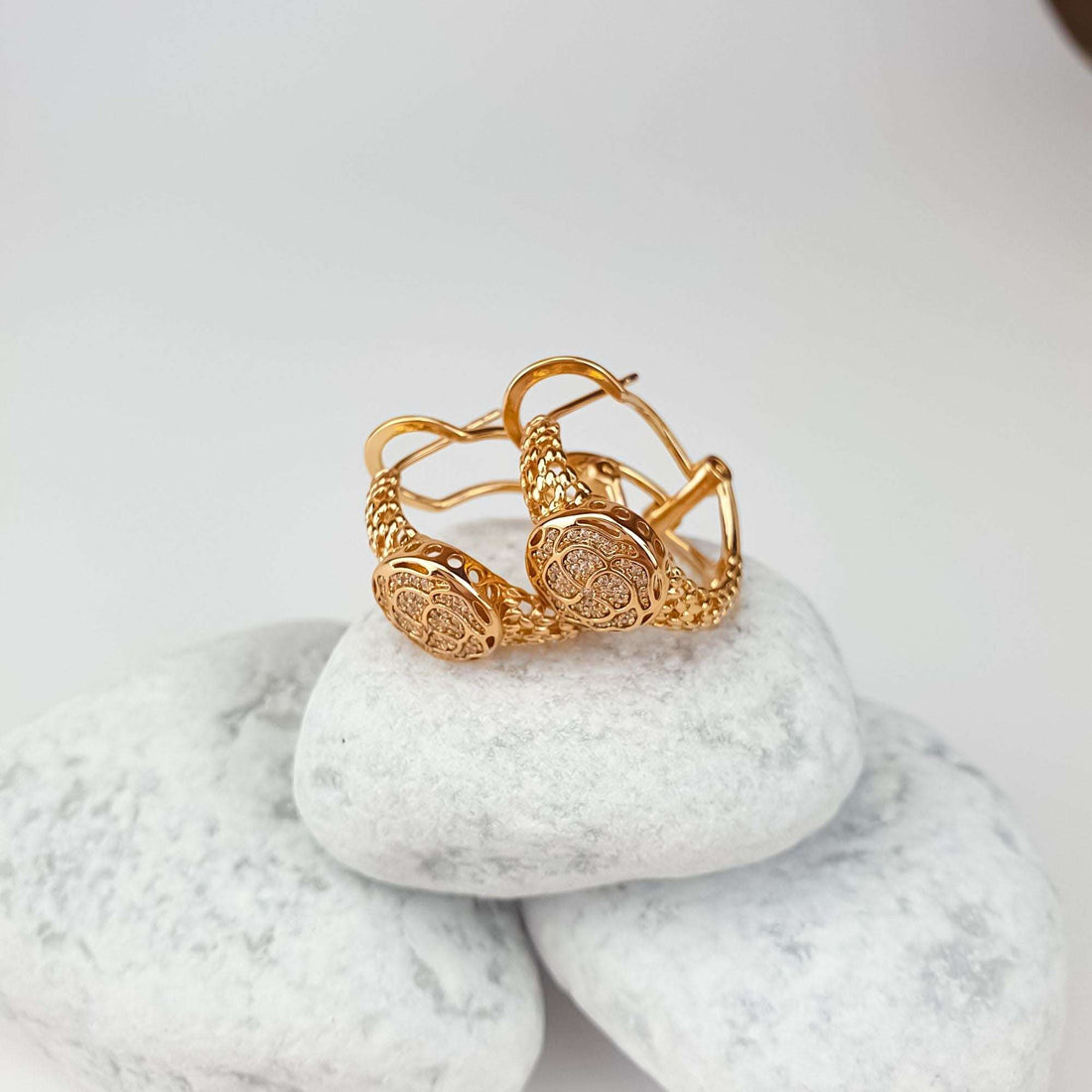 Gold-plated earrings with a rose petal pattern and tiny cubic zirconia on white stones