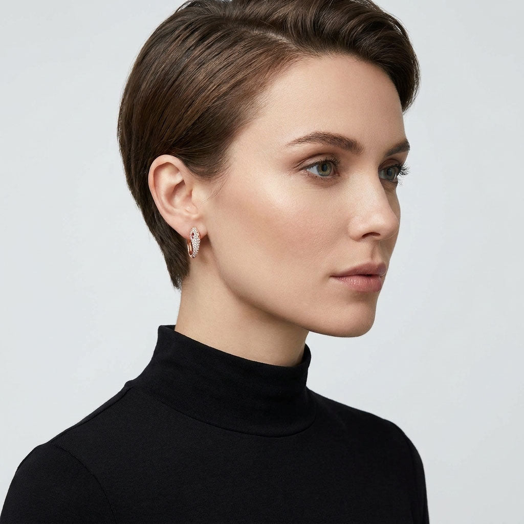 Model in a black polo neck wearing a gold-plated snake earring, profile close-up
