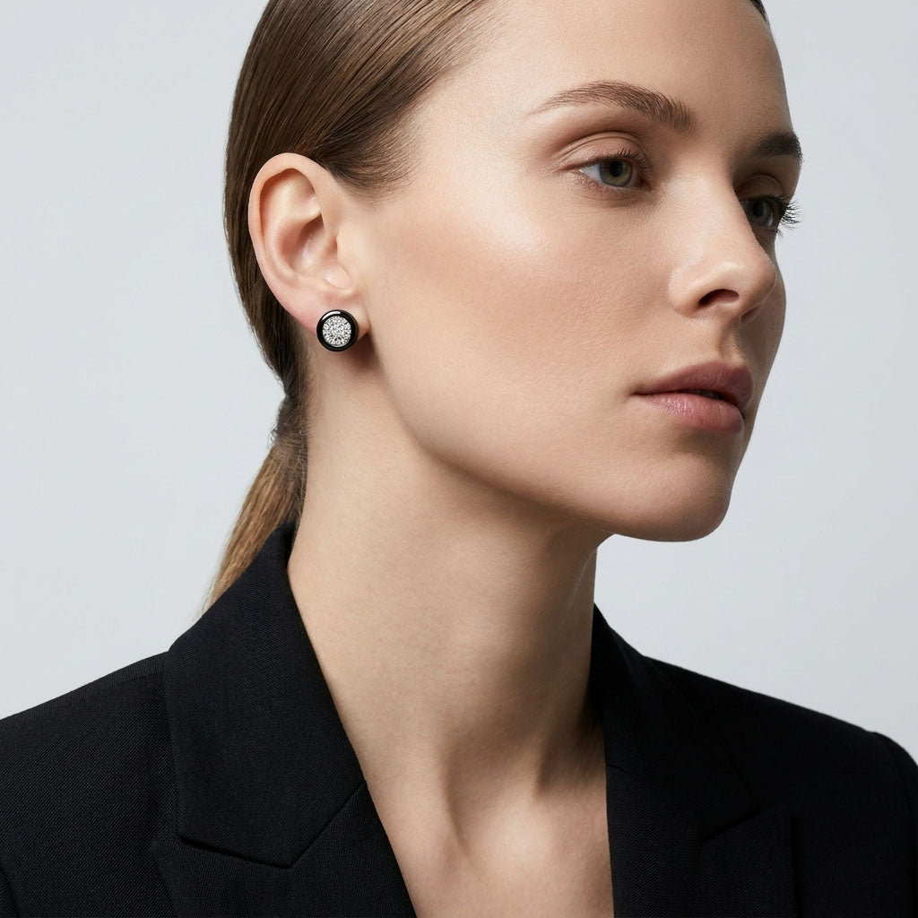 Model wearing round black ceramic earrings with cubic zirconia