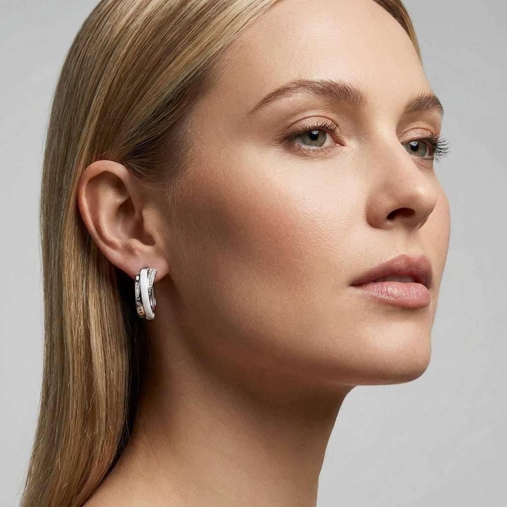 Model wearing geometric earrings, close-up of the white band and cubic zirconia