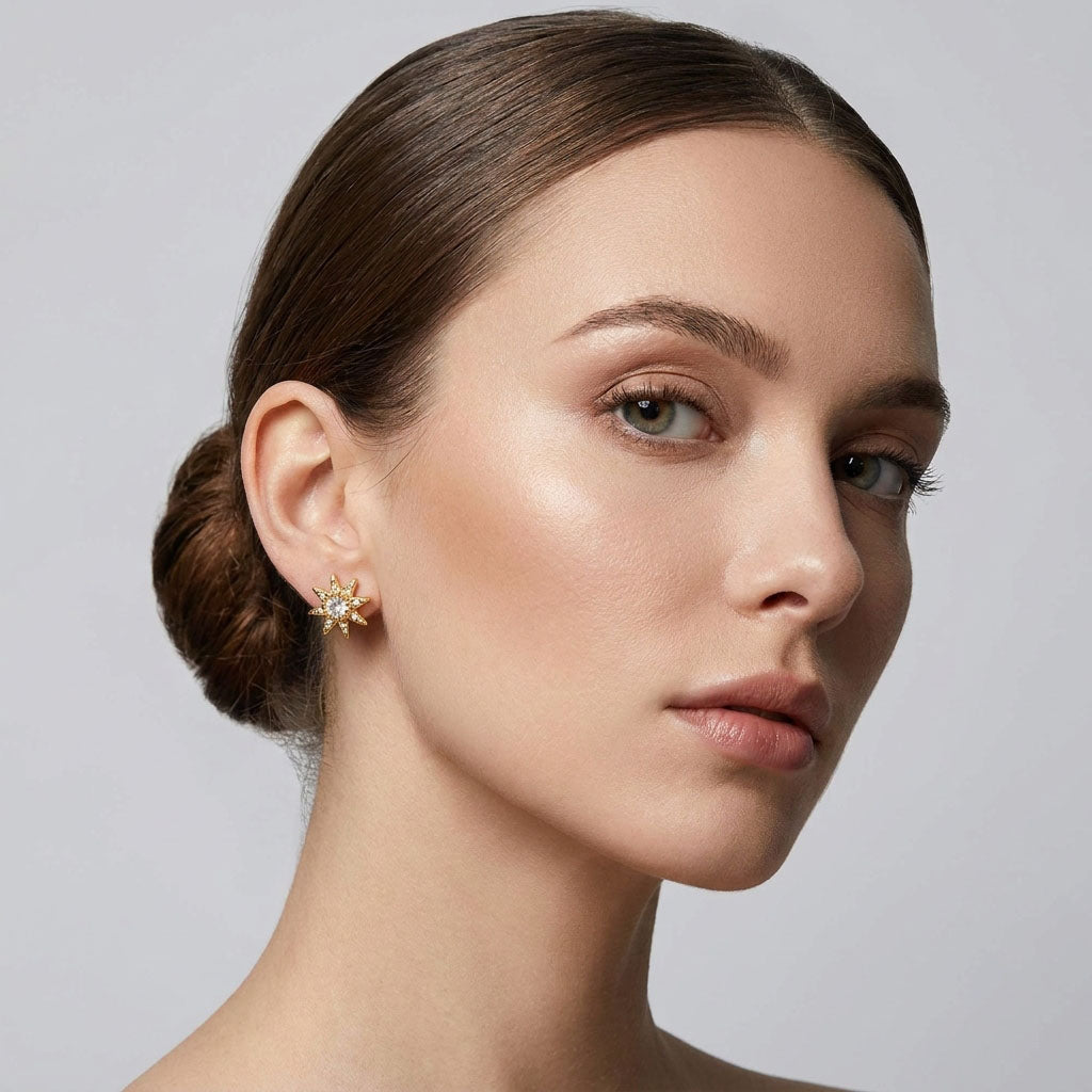 Model wearing a gold-plated star earring, the cubic zirconia sparkling against fair skin
