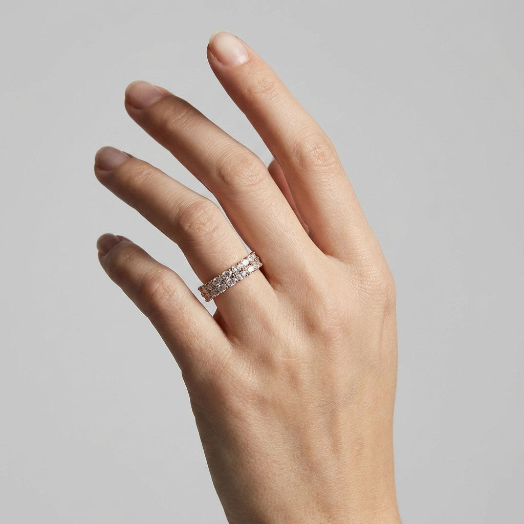 Gold-plated ring with two rows of clear crystals on a woman's finger