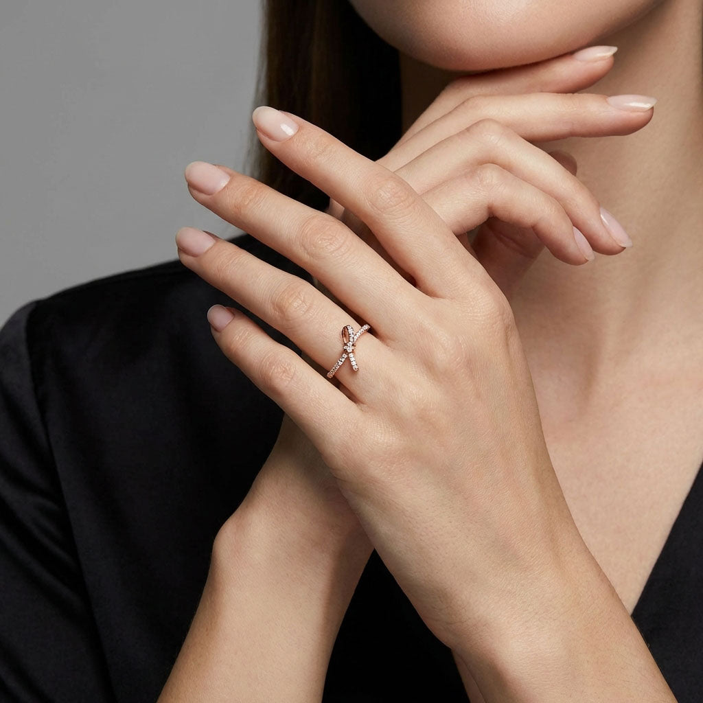 Woman wearing the gold-plated knot ring, close up against a black blouse